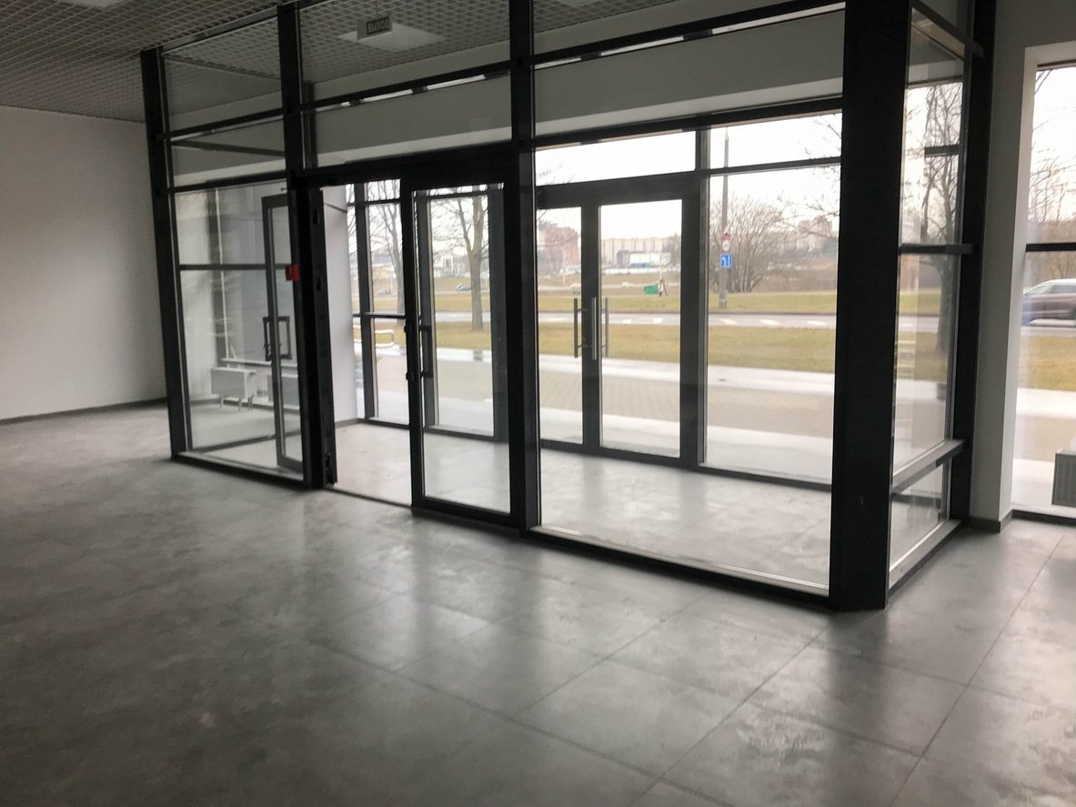 The glass entrance at the entrance to the building store office with sliding double doors.