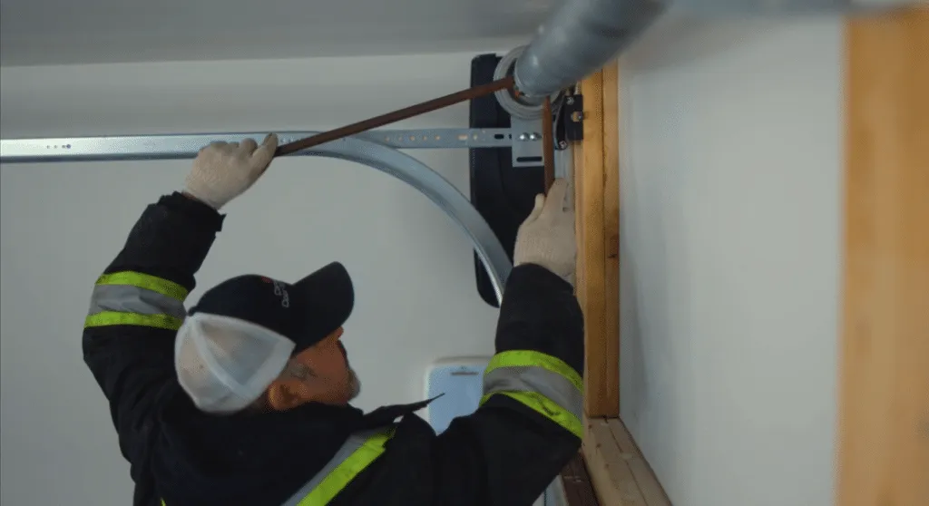Garage Door Technician winding a torsion spring