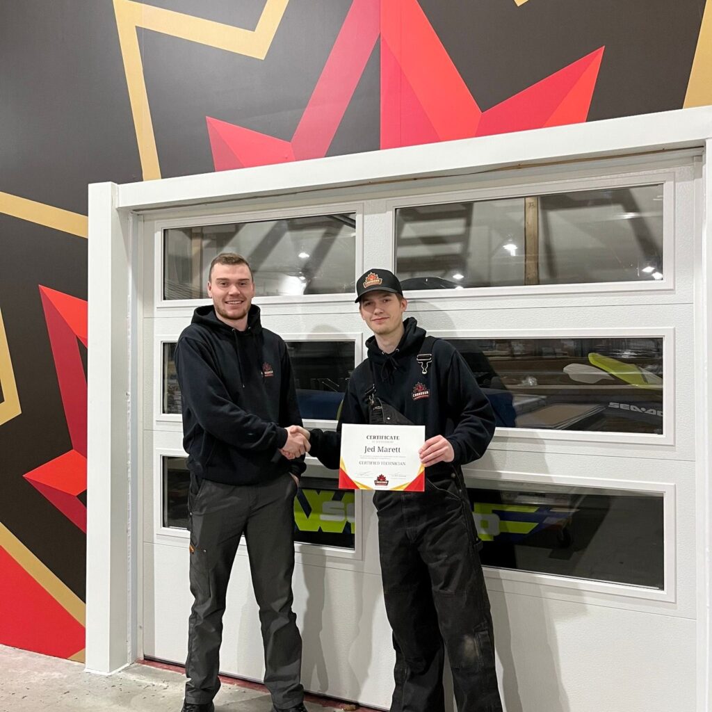 Garage Door Technician becoming certified by his supervisor in our garage door training centre