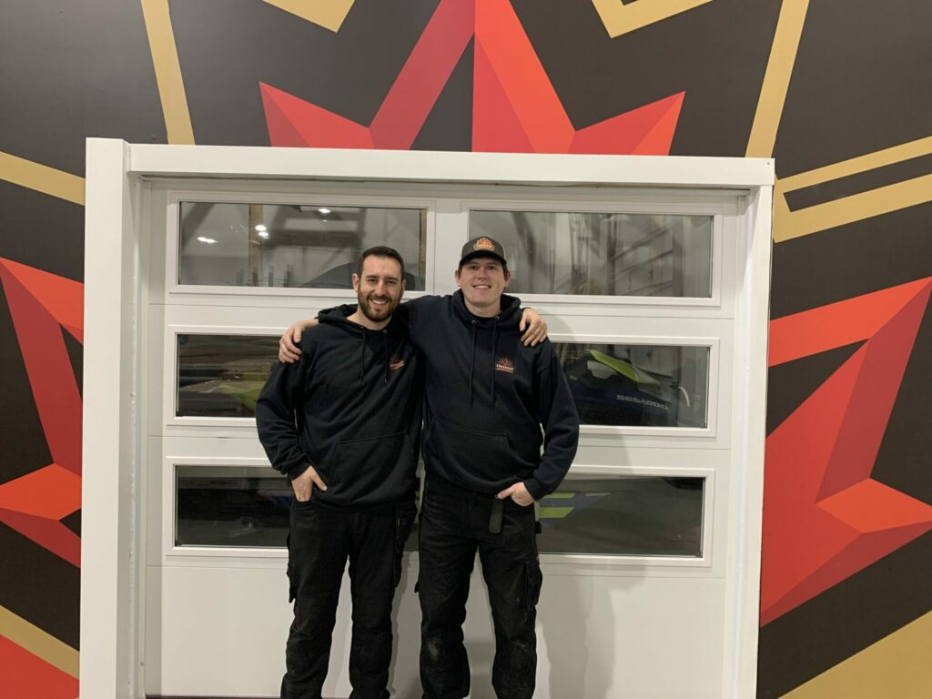 two certified garage door technicians working in our garage door training centre
