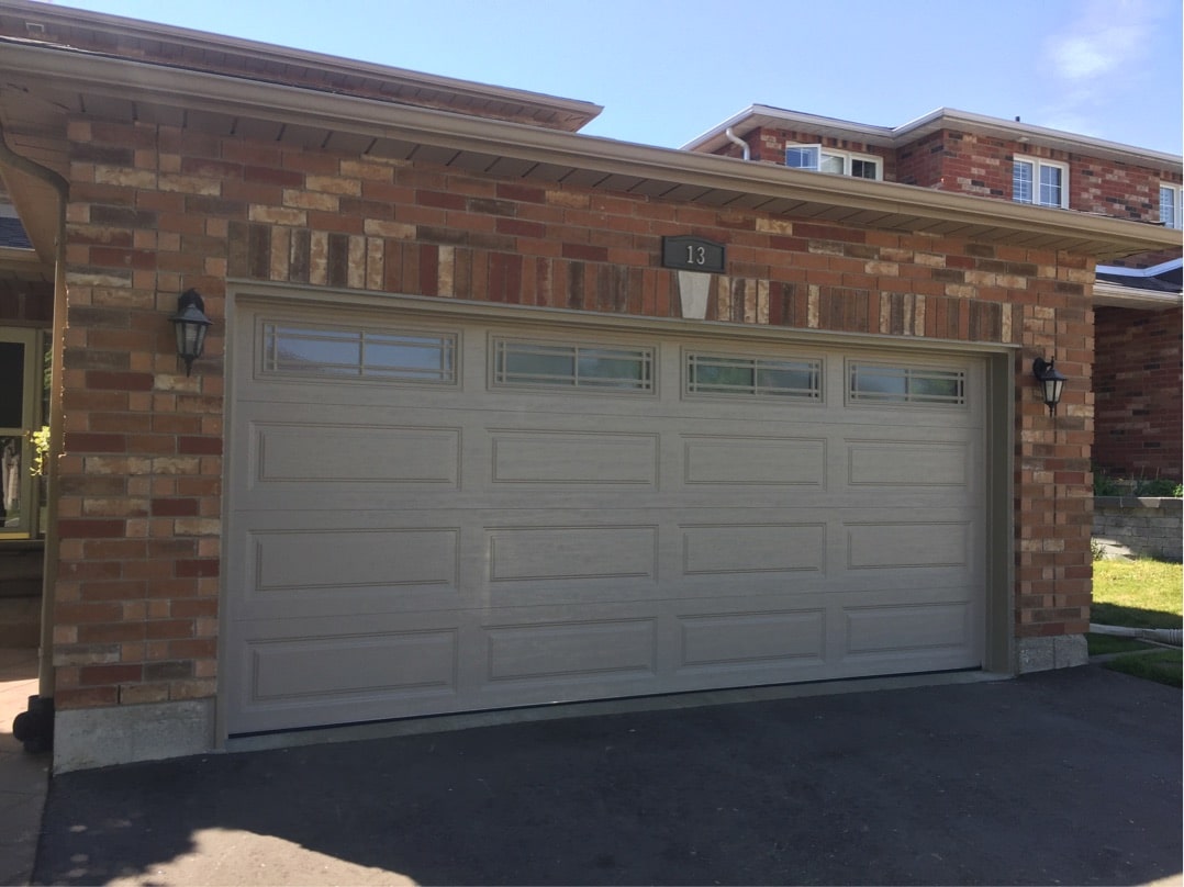 Brick home with new Clopay garage door