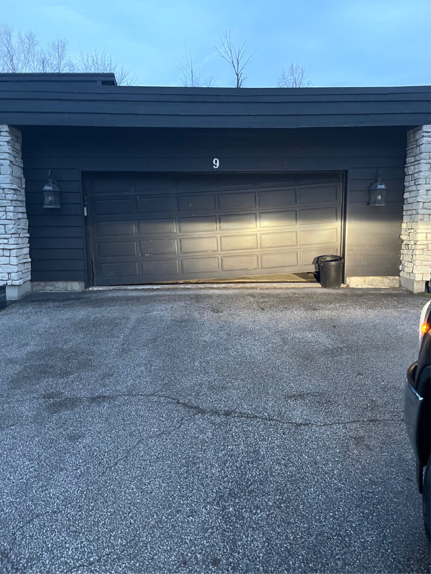 garage door with a broken cable causing the garage door track to bend
