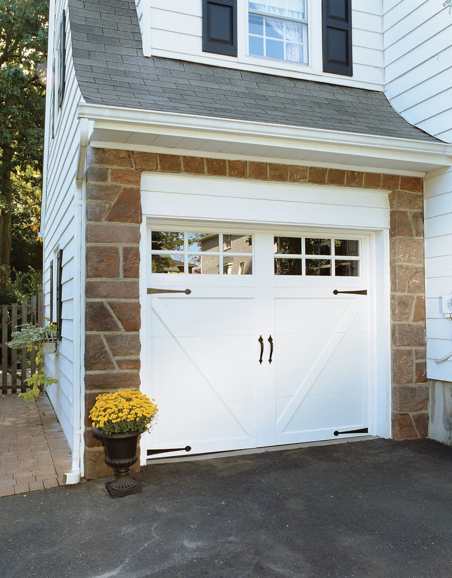 white garage door with windows on a older style home
