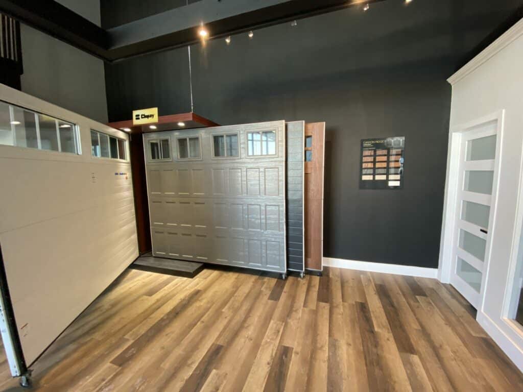 Charcoal coloured garage door on display in a garage door showroom in Barrie Ontario