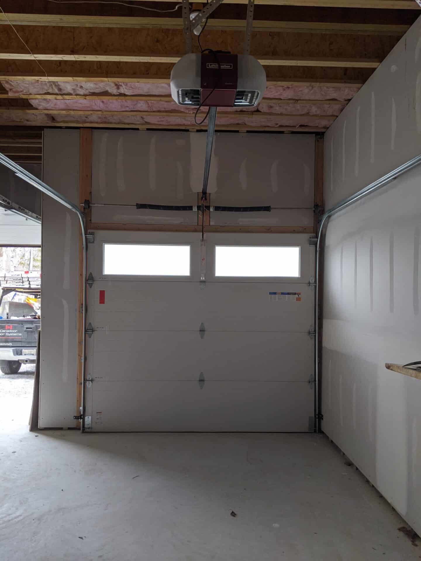 inside of a garage door showing faulty garage door springs