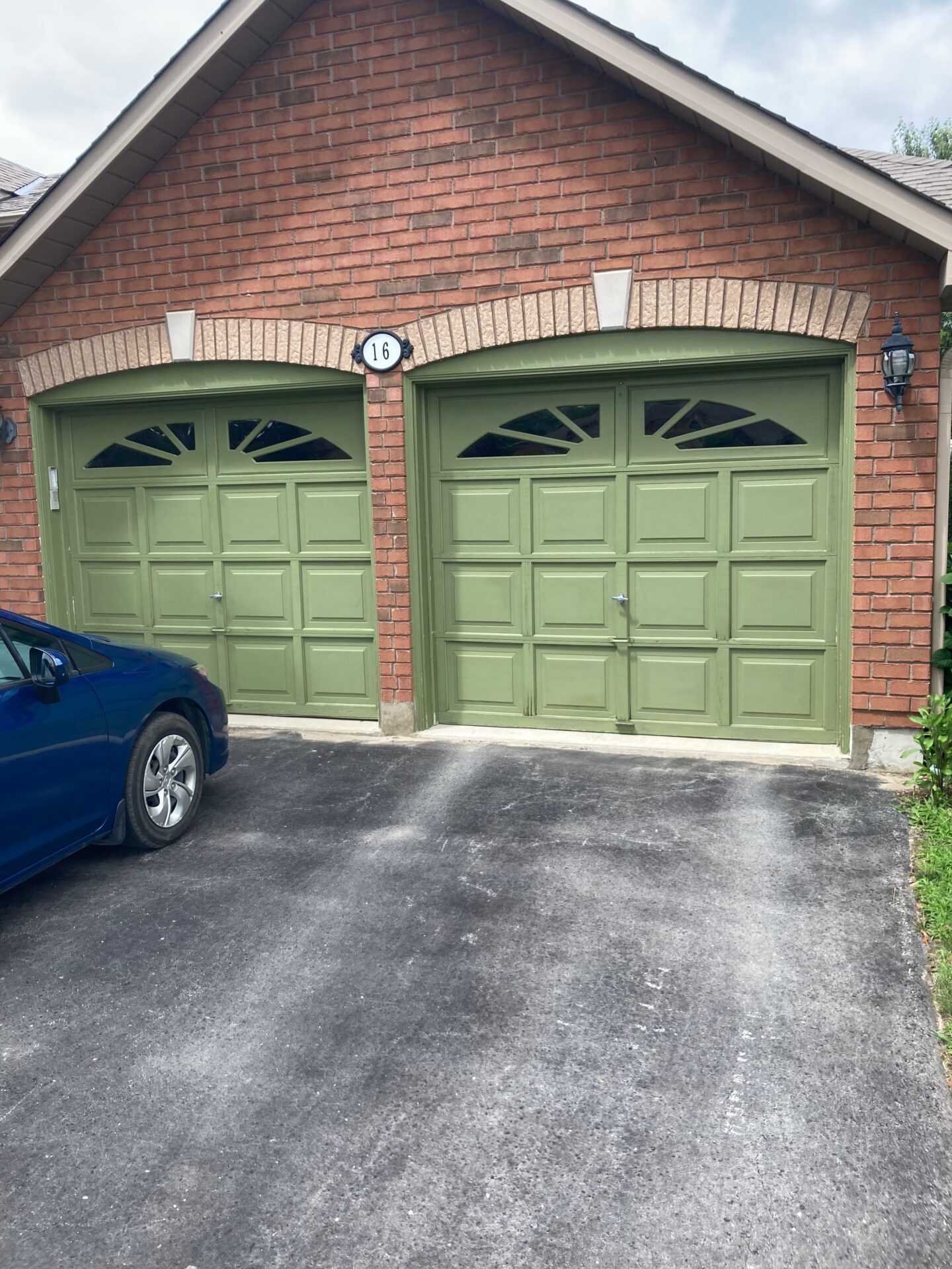 wooden garage doors on a brick home in Barrie Ontario