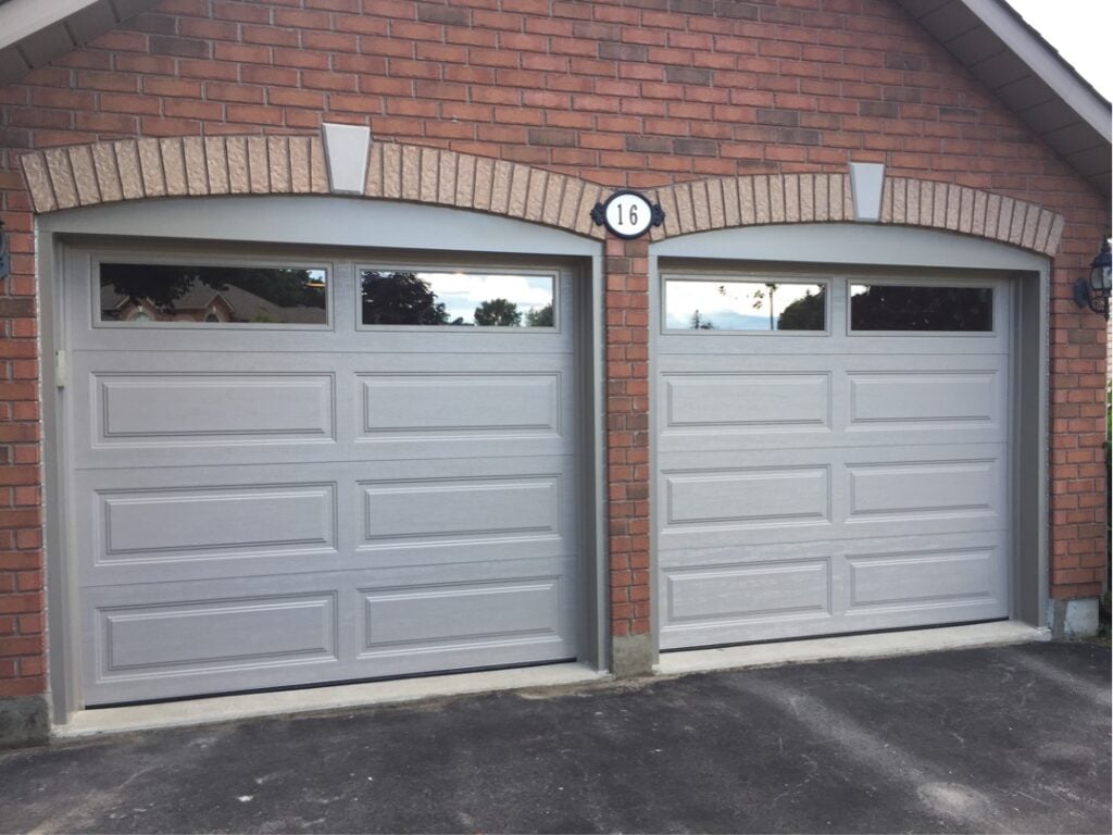 Gary long panelled garage doors with plain windows and an arched header