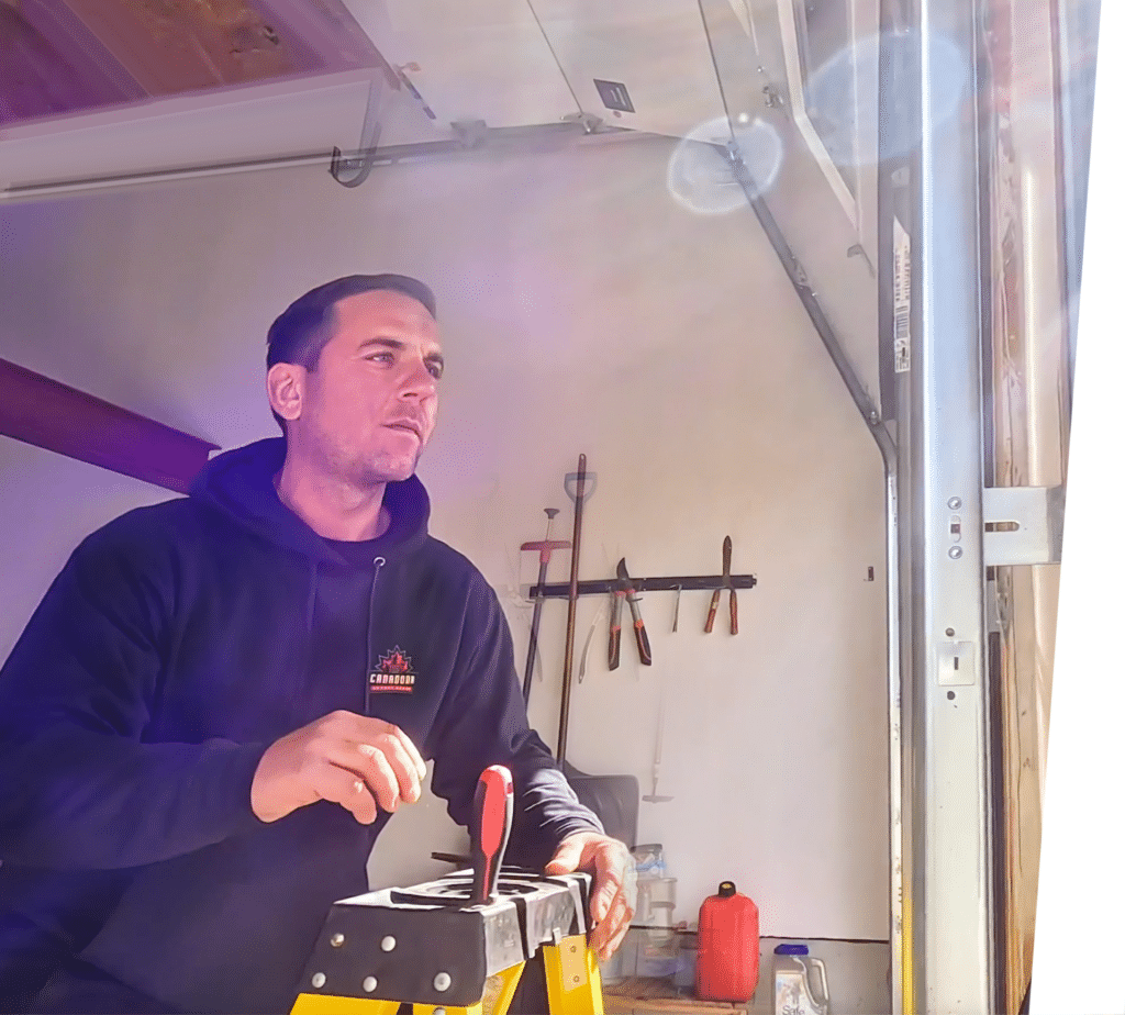garage door technician on a ladder working on a Clopay garage door for a homeowner in Barrie Ontario Canada