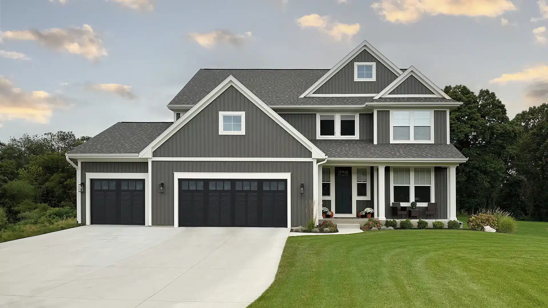 Black faux wood garage door on a grey house with white accents