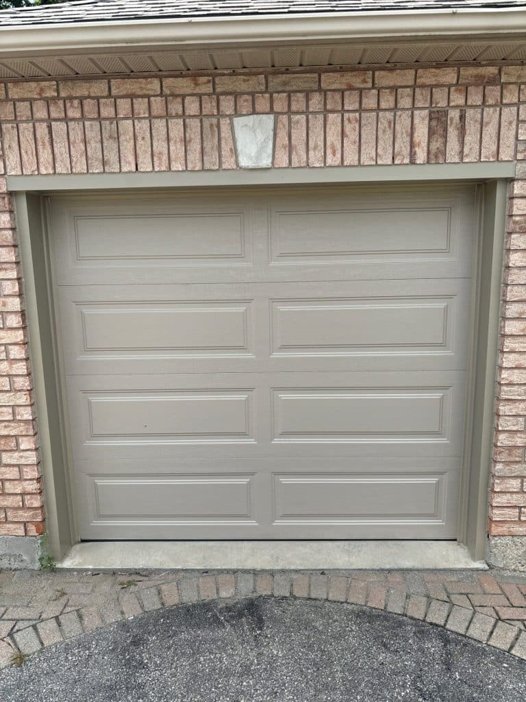 Garage door technician performing safety measures during a repair