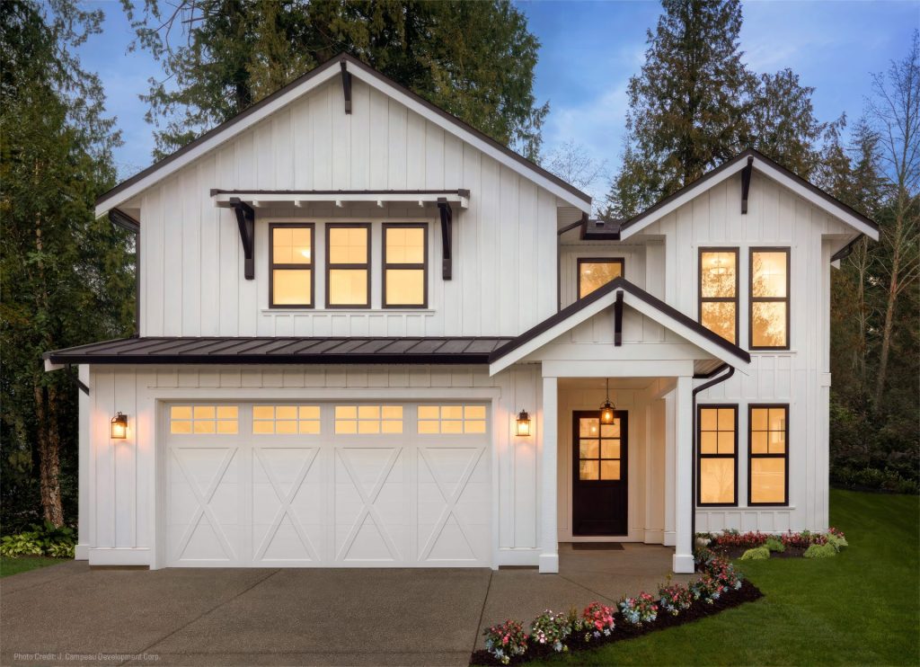 White carriage-style garage door with decorative windows on a modern farmhouse home