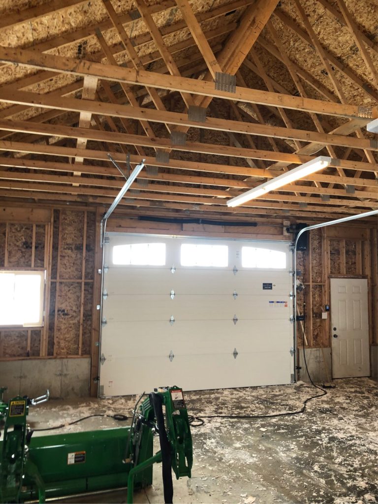 White sectional garage door with windows installed in a residential garage