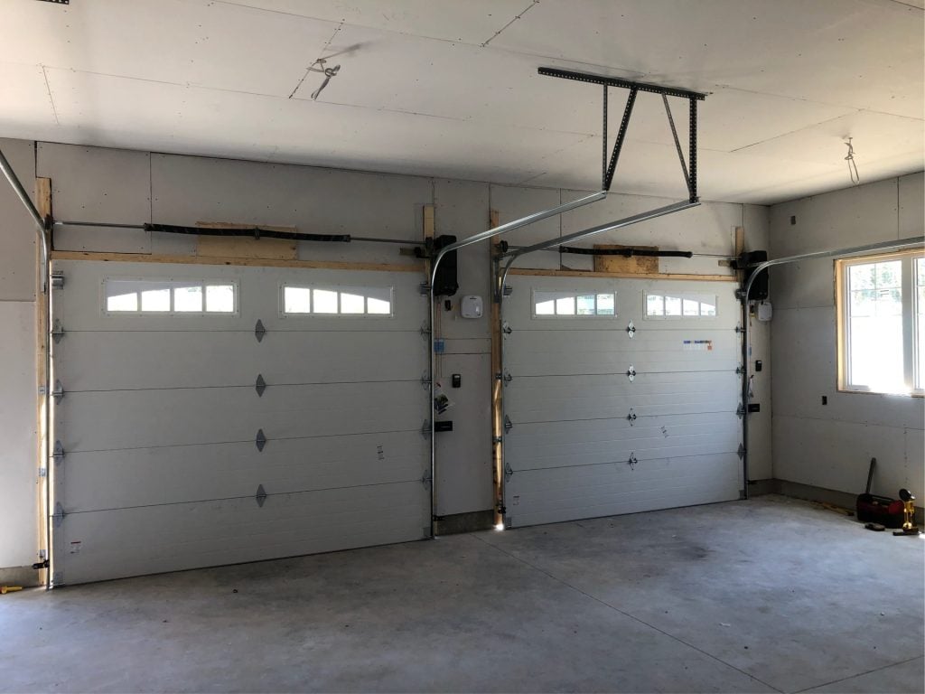 Two garage doors installed in a residential garage