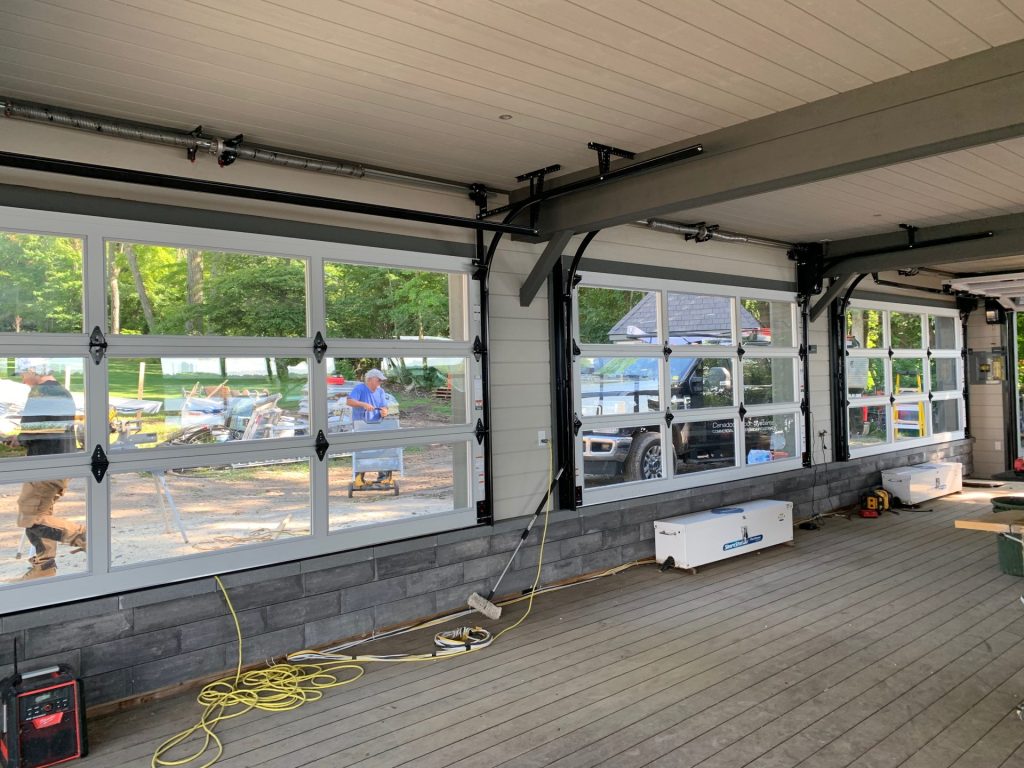 Commercial garage door installation with full-view glass doors